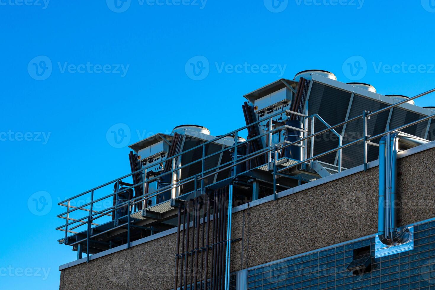 Rooftop air conditioning units under clear blue sky photo