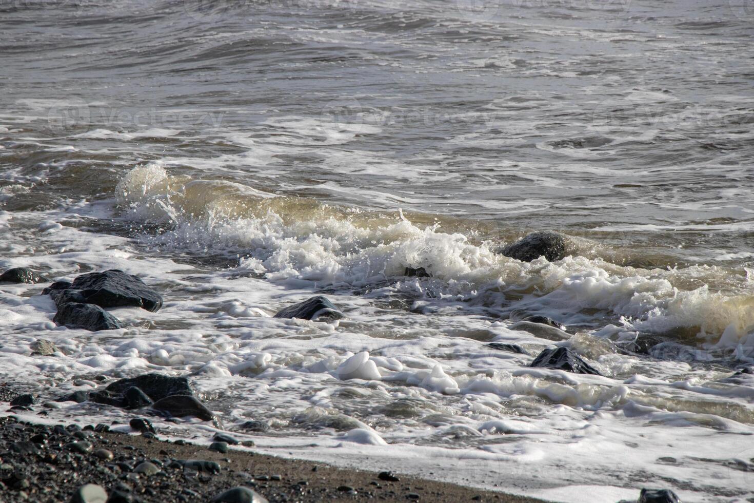 ocean wave breaking on the coast photo
