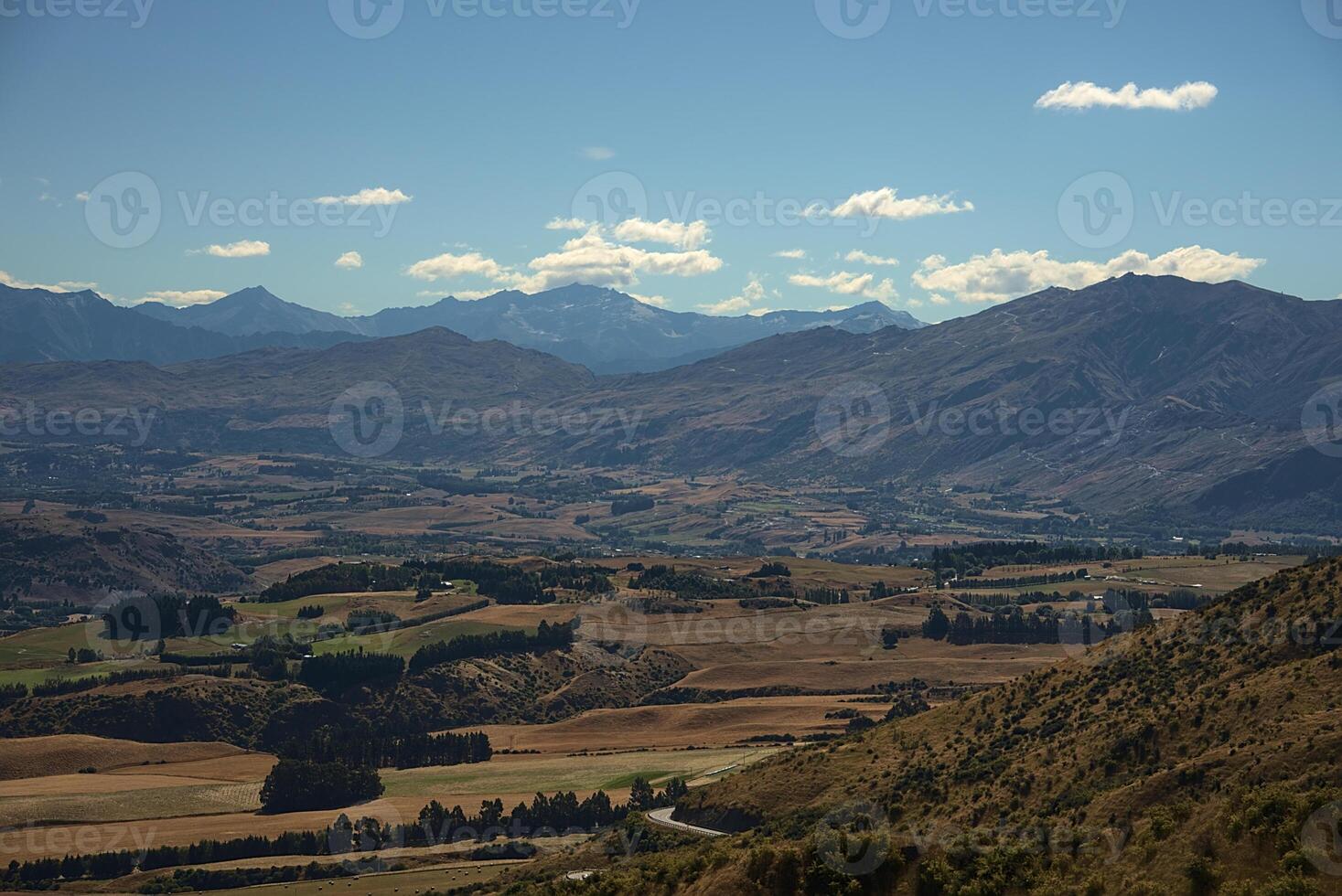 A view of a valley with mountains in the background photo