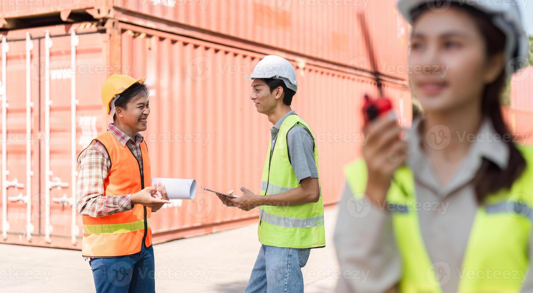 Construction team engaging in discussion with blueprints and communication tools on-site photo