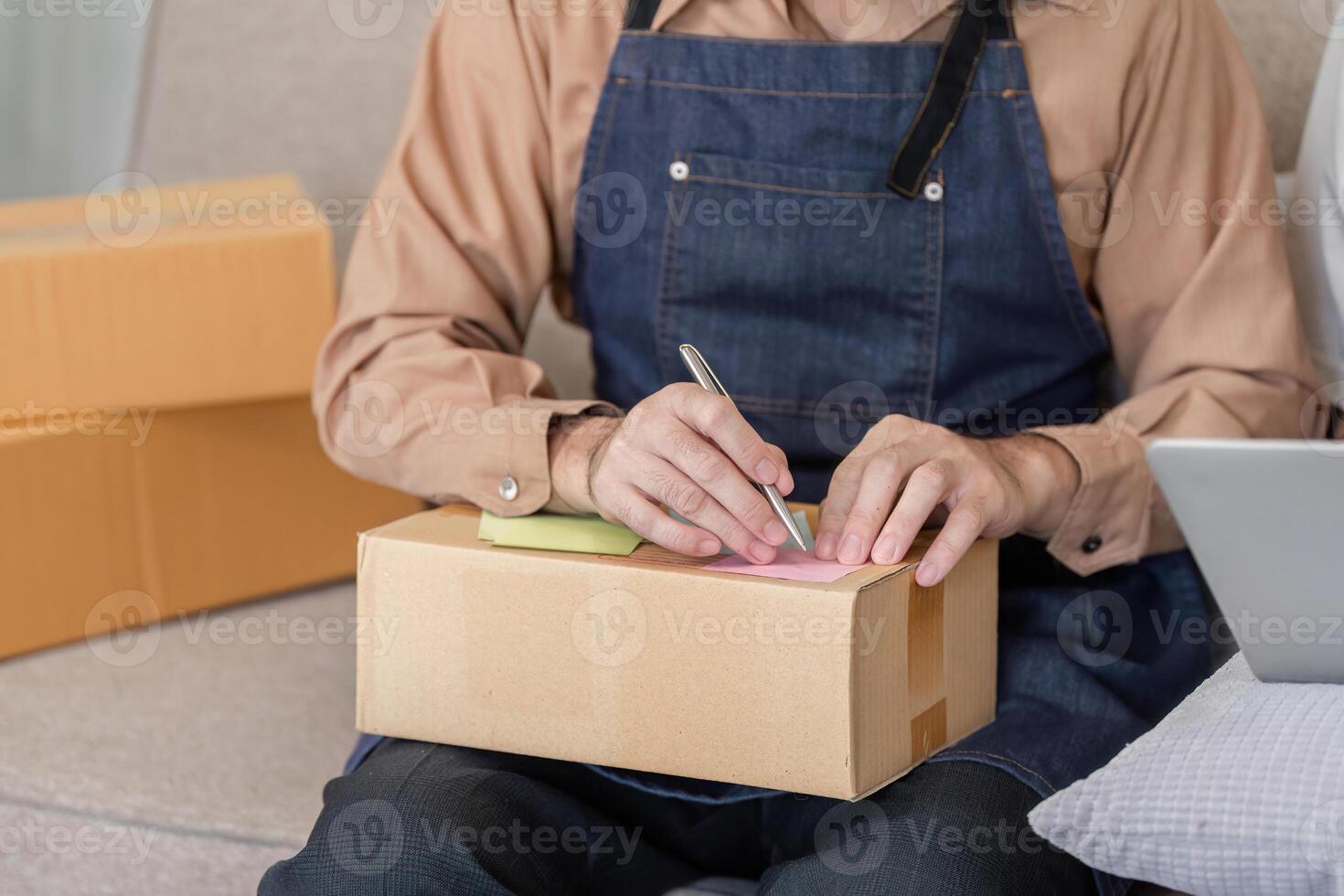 Delivery professional labeling packages with notes in a cozy workspace, emphasizing attention to detail photo