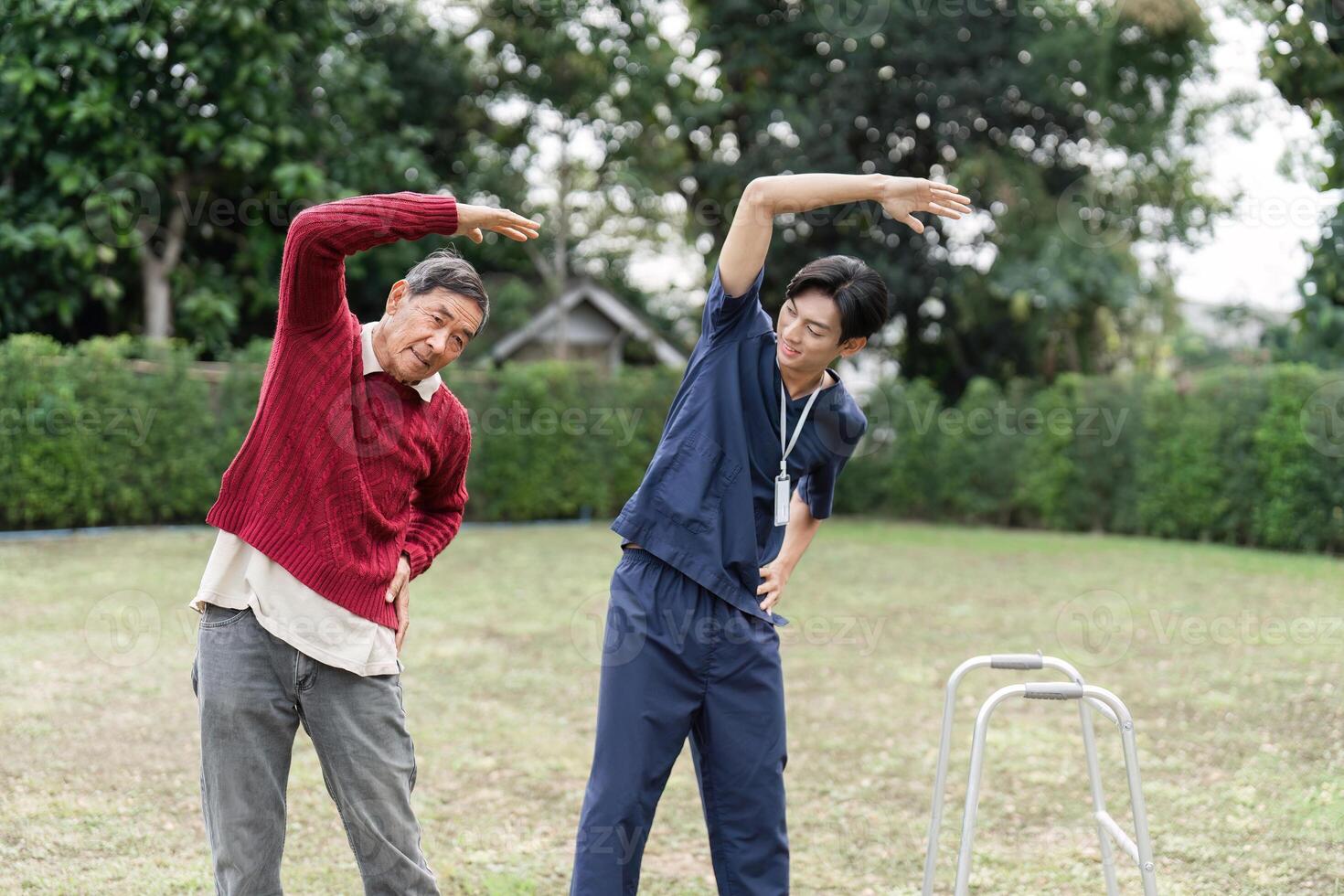 Health caregiver assisting elderly man with stretching exercises outdoors for rehabilitation therapy photo