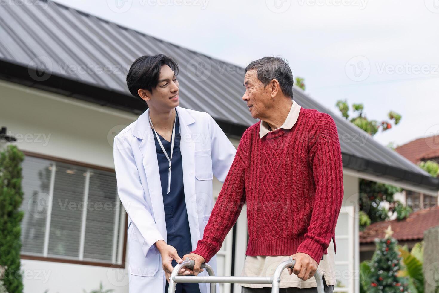 Compassionate doctor engaging with elderly man using walker in tranquil garden environment photo