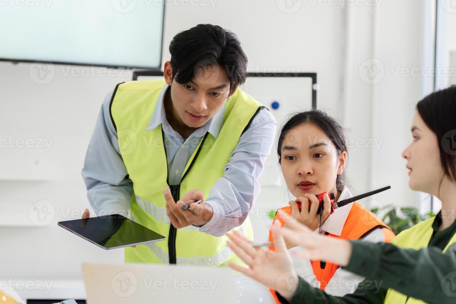 Construction manager leading project discussion with visuals and instructions in a meeting photo
