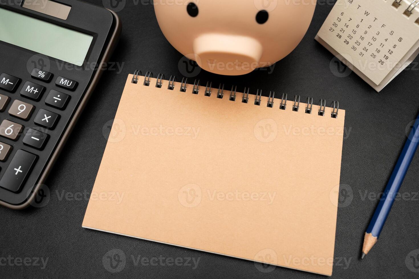 Blank Notebook with Piggy Bank, Calculator and office supplies. Copy space for text. Place for an inscription, business concept. photo