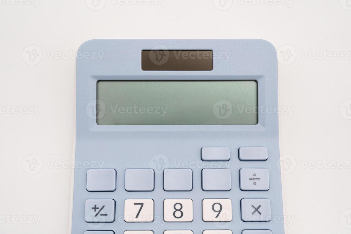Light blue digital calculator on isolated background. photo