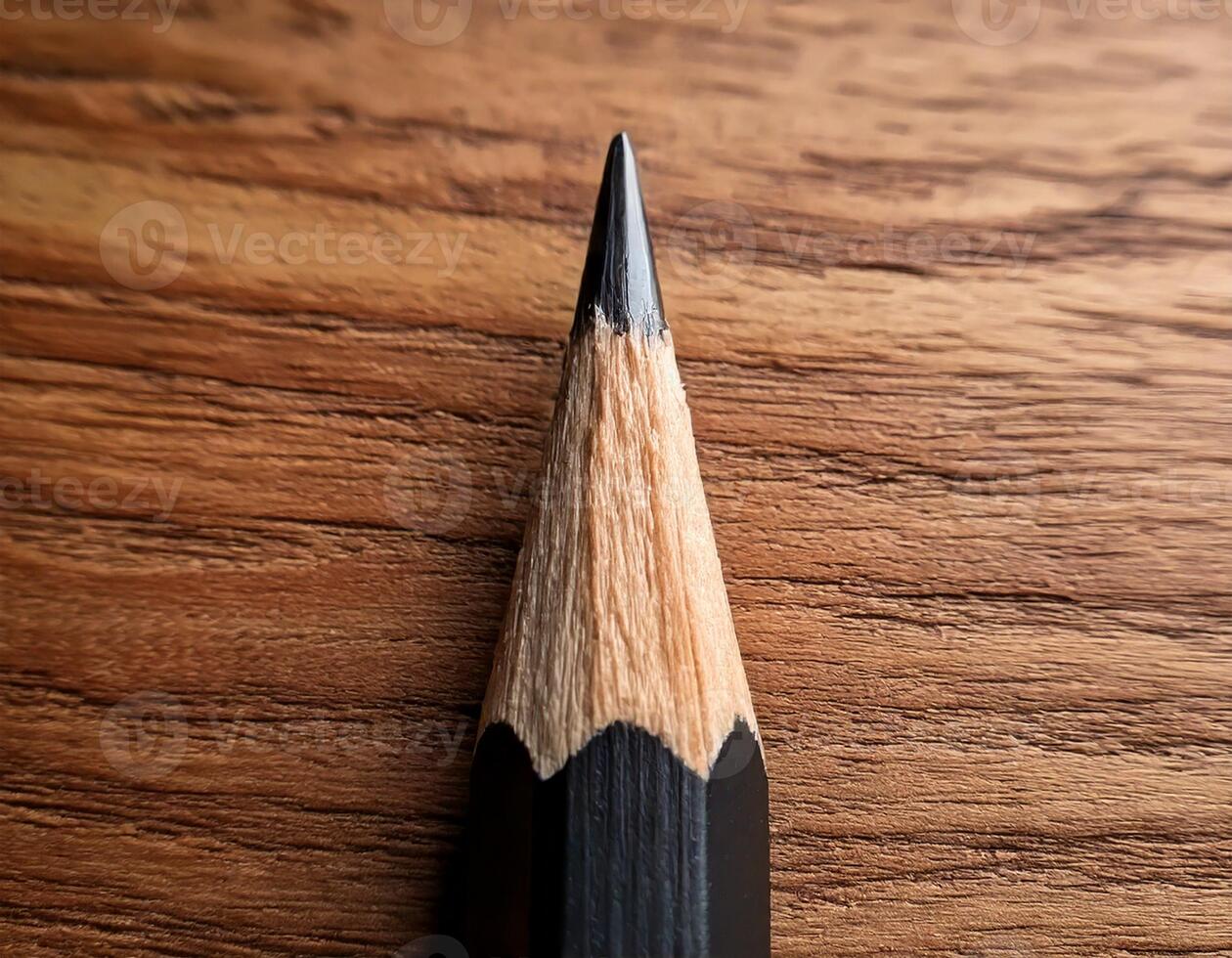 sharp pencil tip with a wooden textured background photo