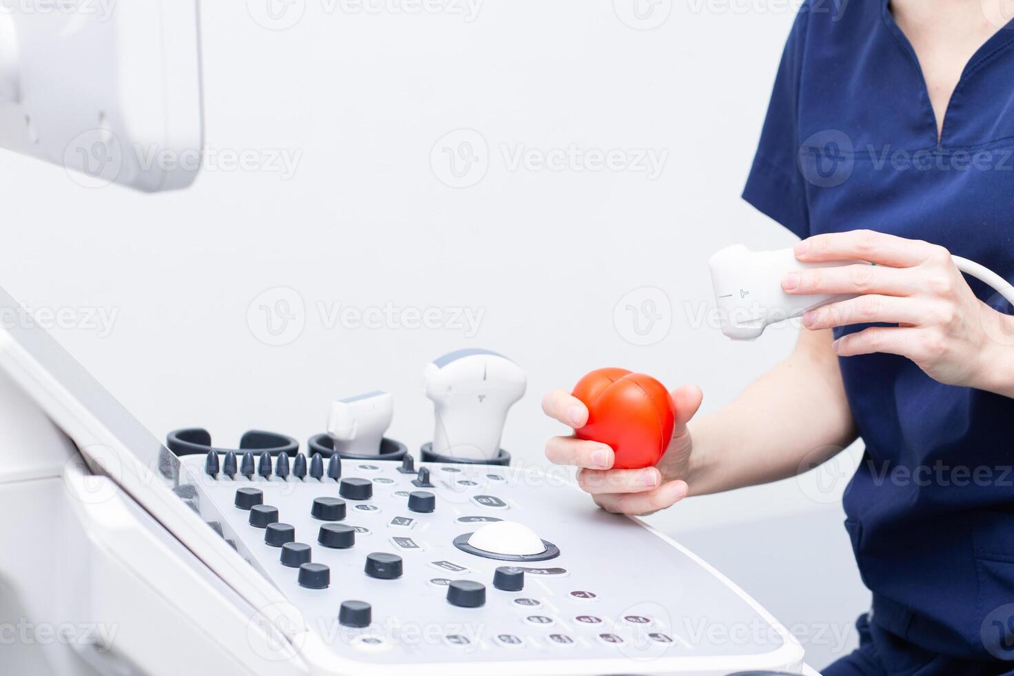 Female doctor sitting in office with ultrasound diagnostic equipment photo