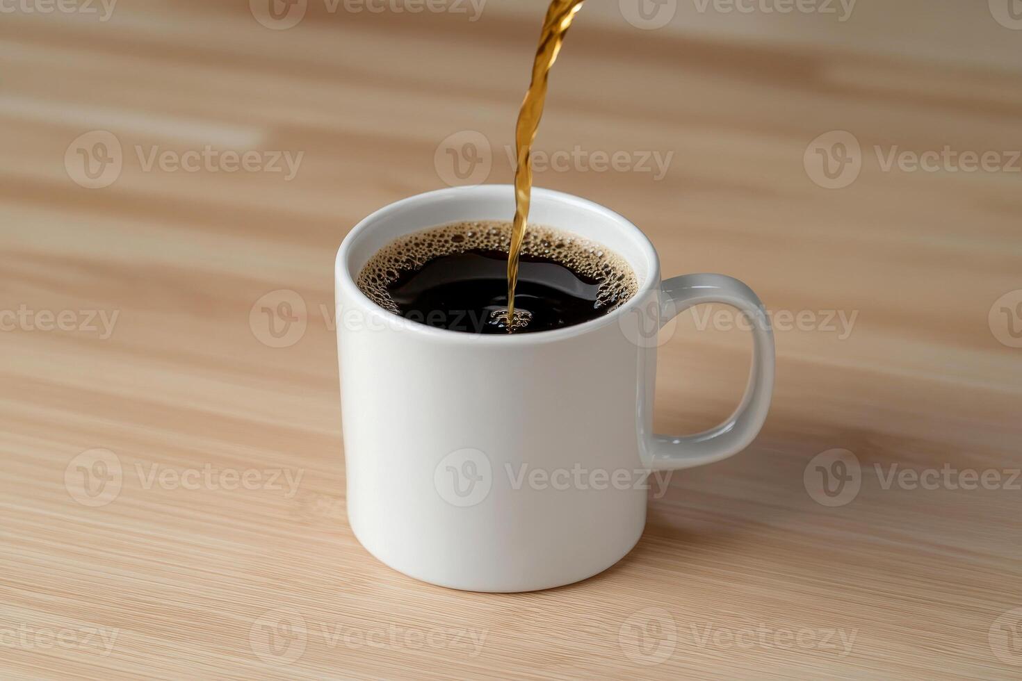 a Close-up of hot black coffee being poured into a white cup on a wooden surface. photo