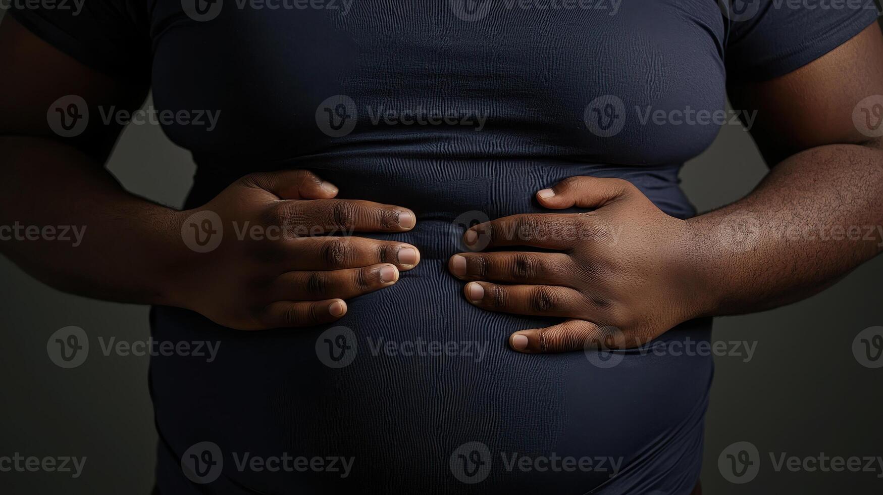 Stomach cramps, hands and African man on isolated background. home with menstruation, periods or constipation. Tummy pain. photo