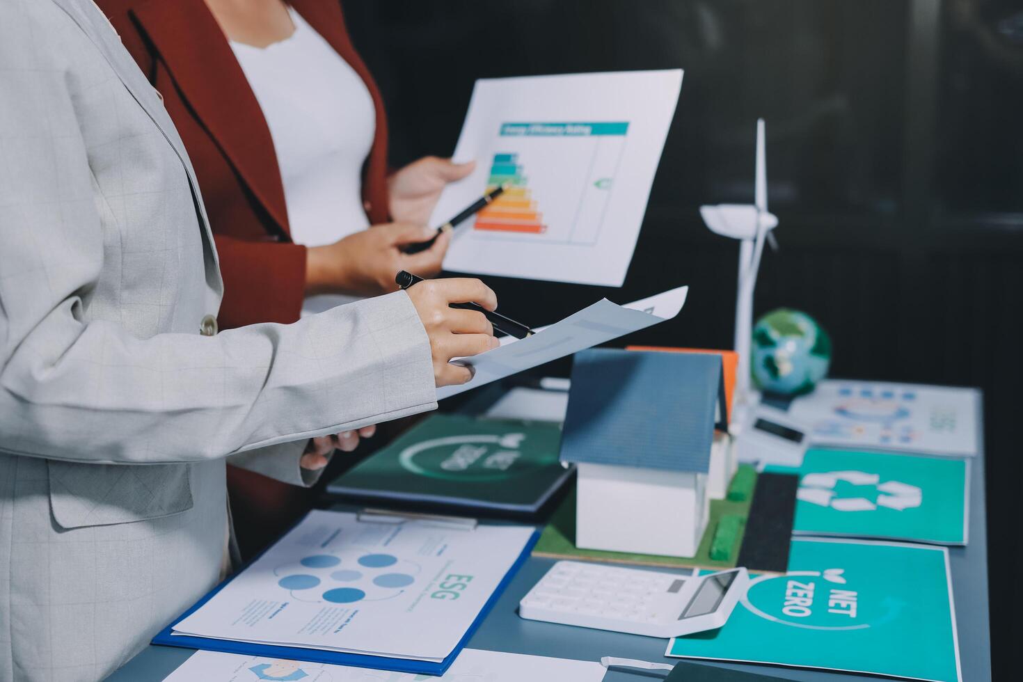 Business people working on a project with papers and graphs photo