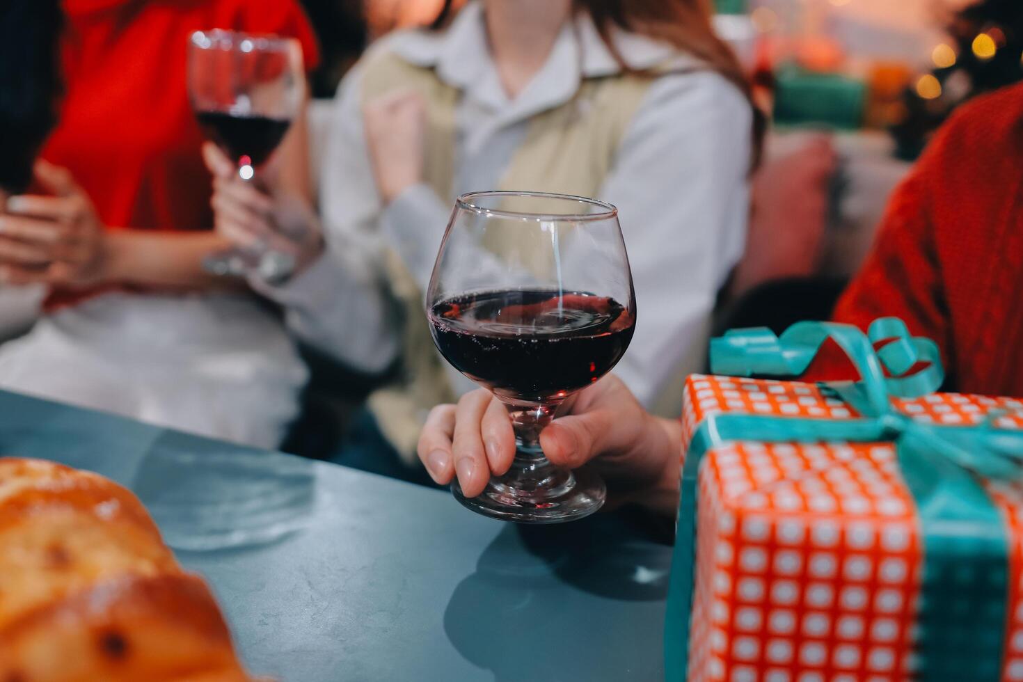 People holding glasses of wine at a christmas party photo