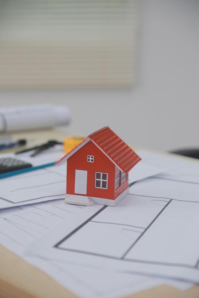 A small house is sitting on top of a desk photo