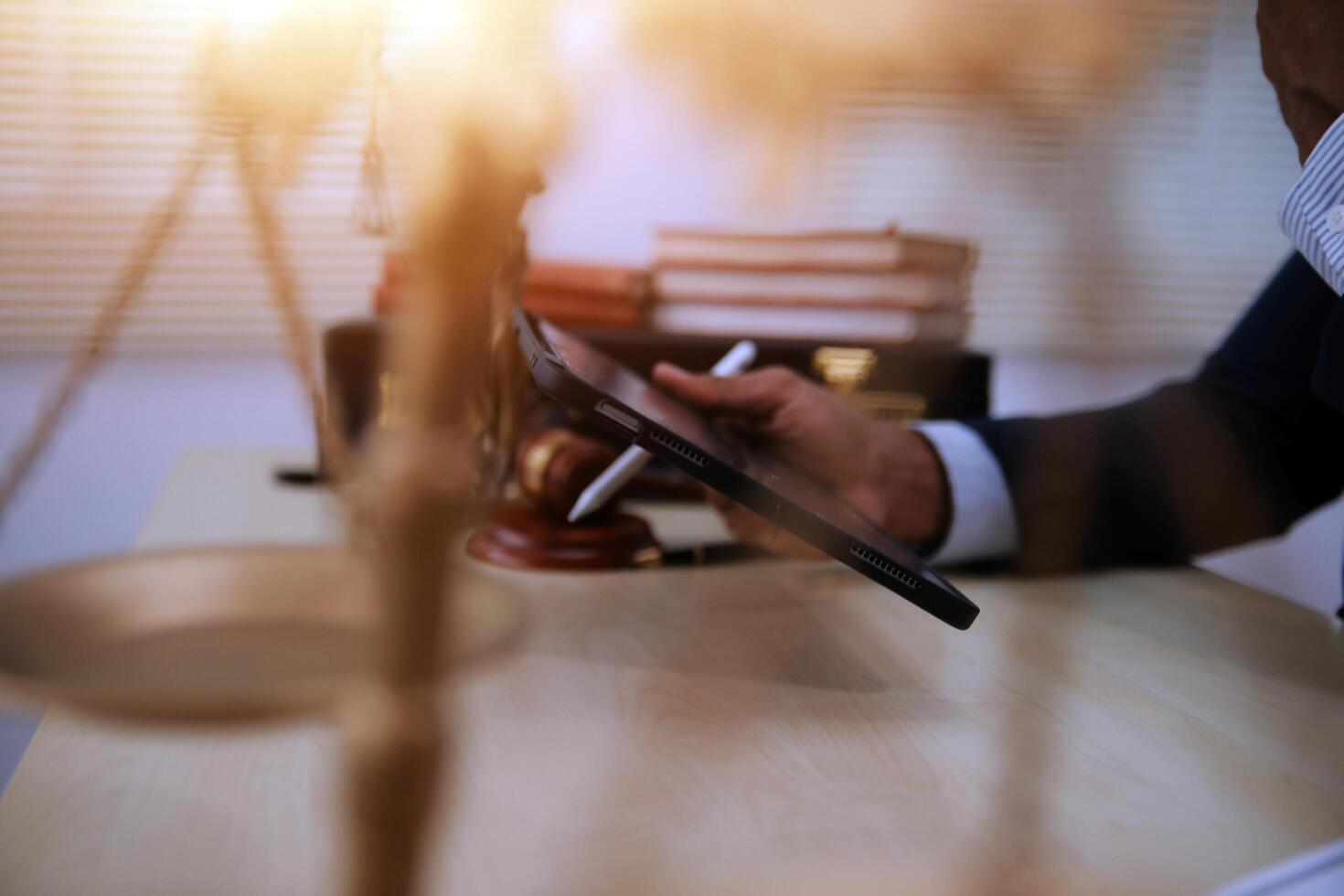 A man in a suit is using a tablet to write a document on a desk photo