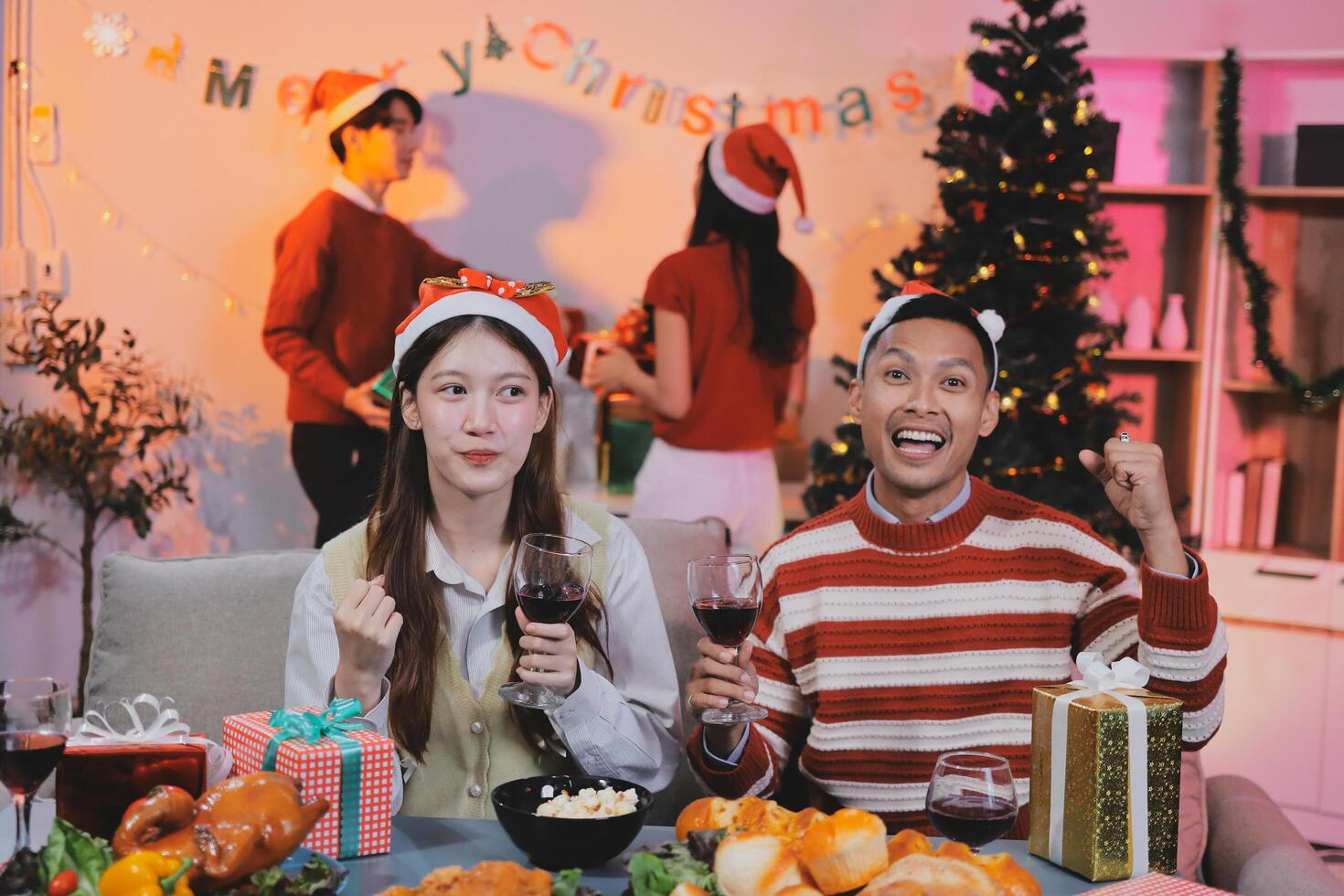 A couple celebrating christmas with wine and food photo