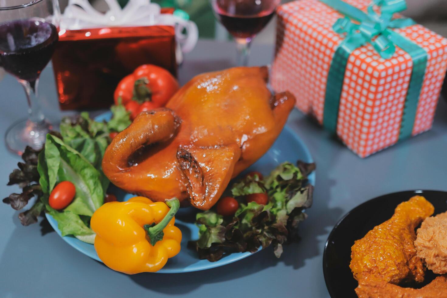 A plate with a chicken, vegetables and a glass of wine photo