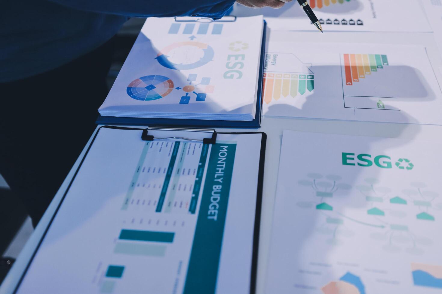 A person is looking at a table with papers and graphs photo