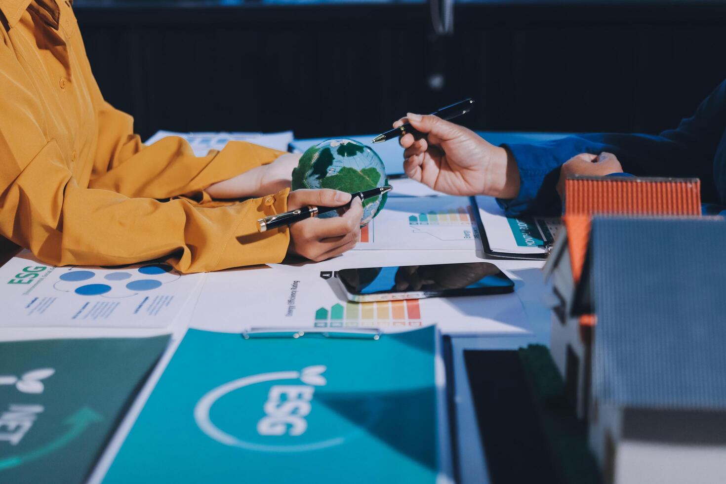 Business people working on a project with a model of the earth photo