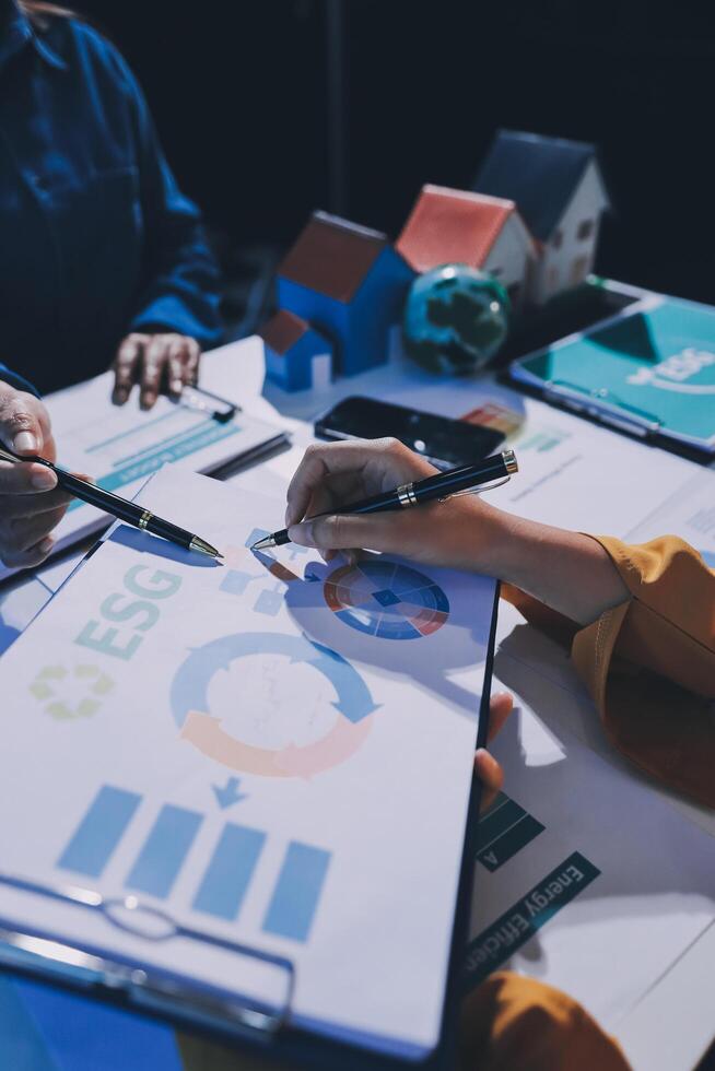 Business people working on a project with graphs and papers photo