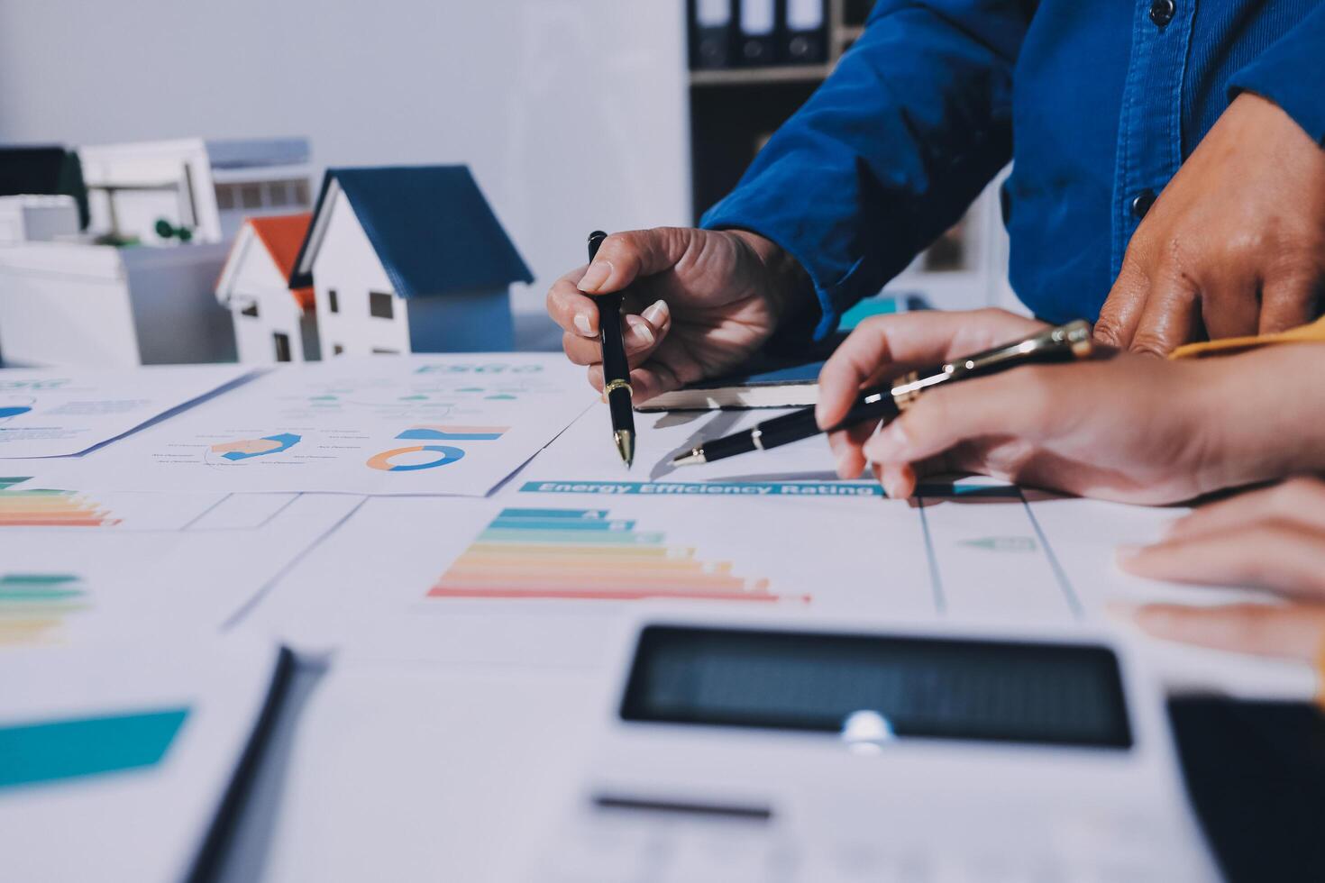 Business people working on a project with graphs and papers photo