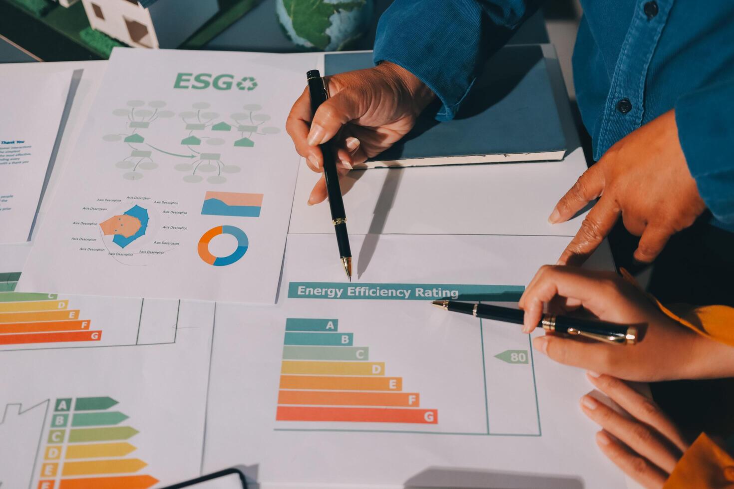 Business people working on a project with eco-friendly energy efficiency graph photo