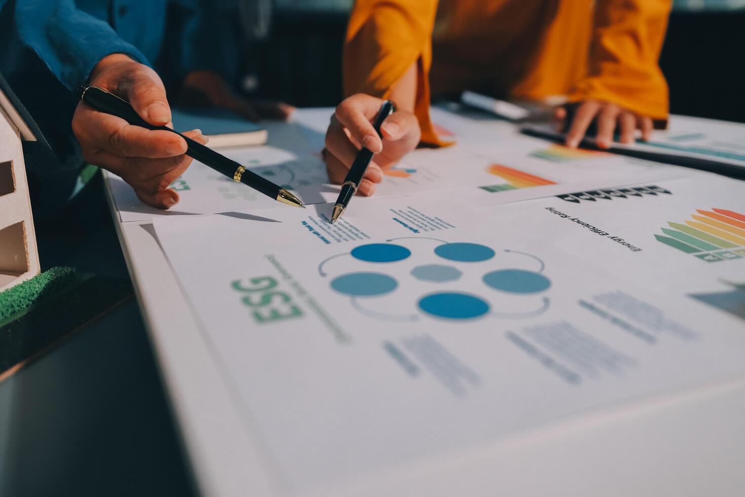 Business people working on a project with graphs and papers photo