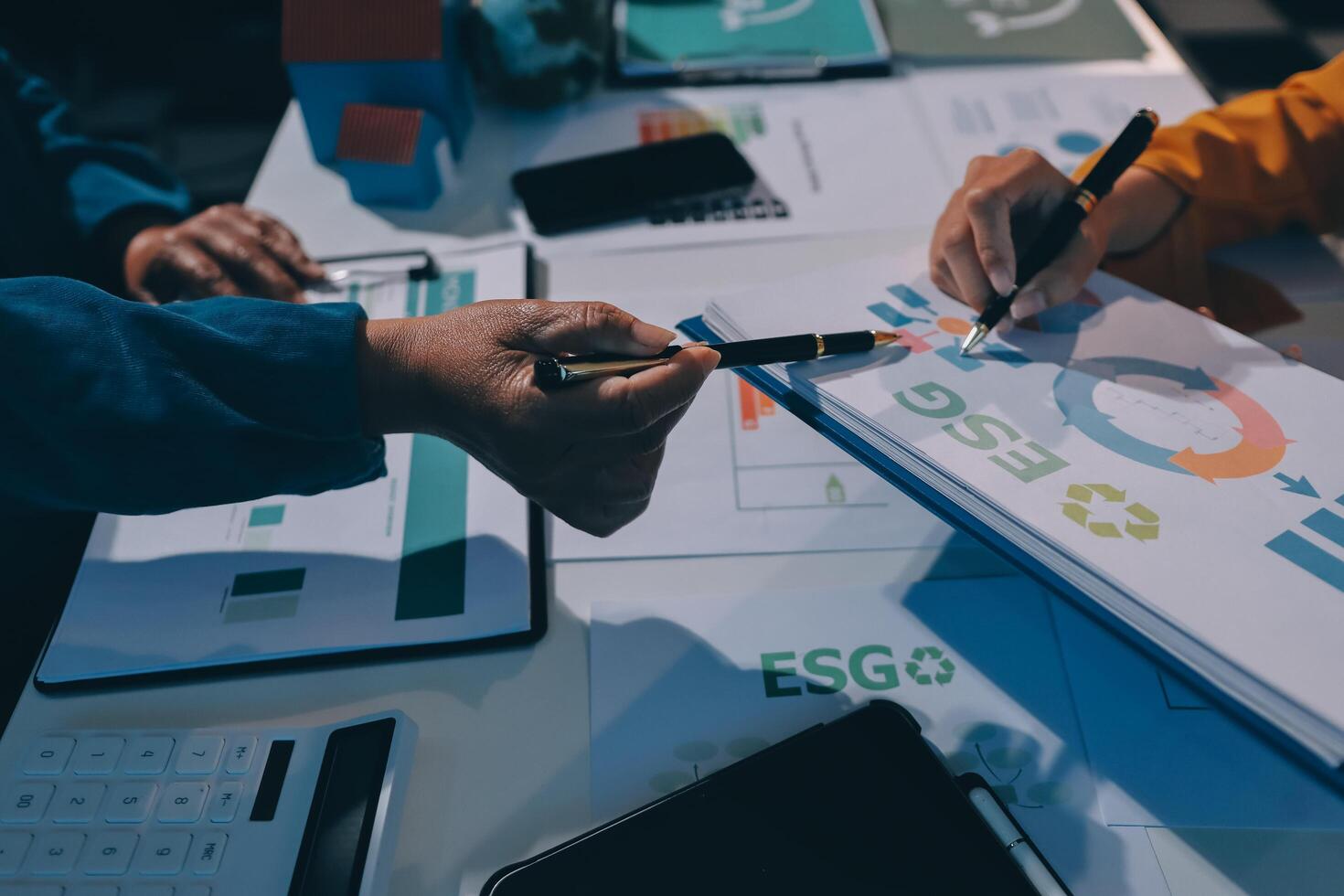 Business people working on a project with graphs and papers photo