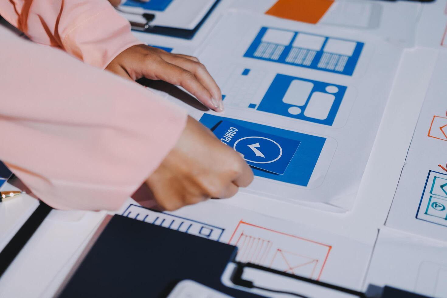 A person is working on a computer with a blue and white logo photo