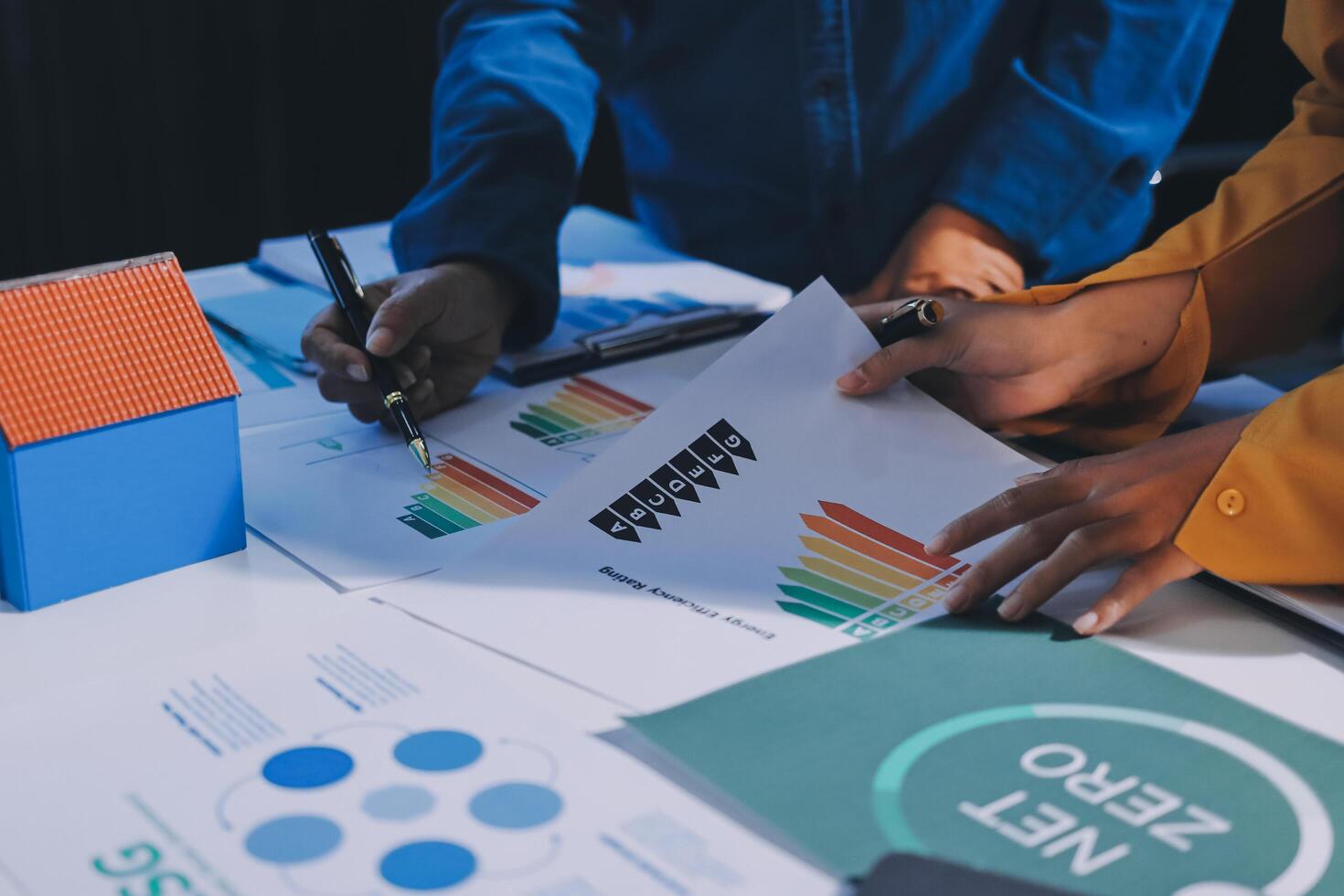 Business people working on a project with graphs and papers photo