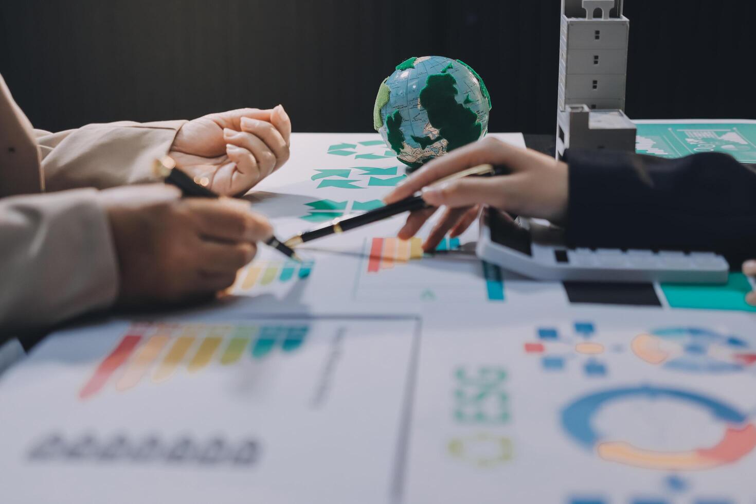 Business people working on a project with a globe photo