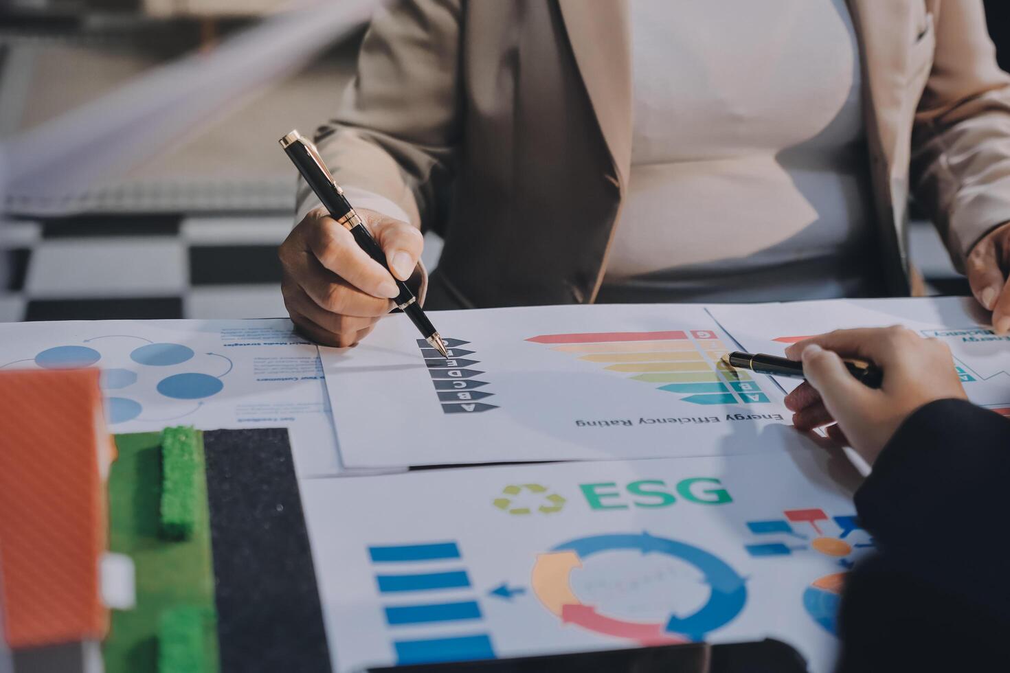 Business people working on a project with graphs and charts photo