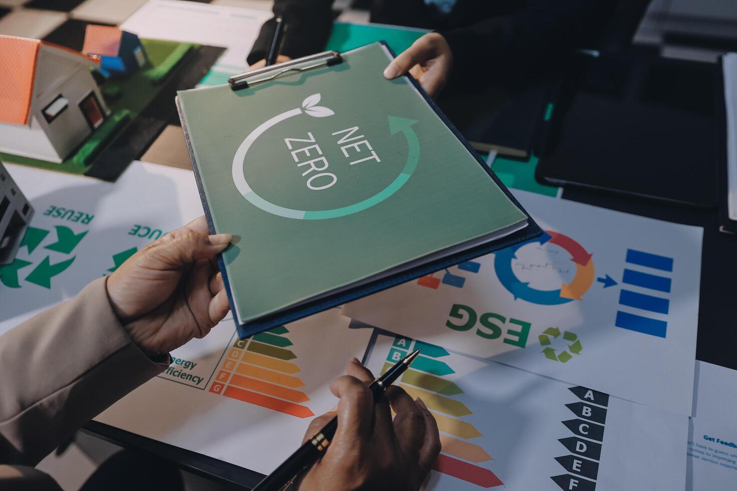 Business people working on a project with a green energy logo photo