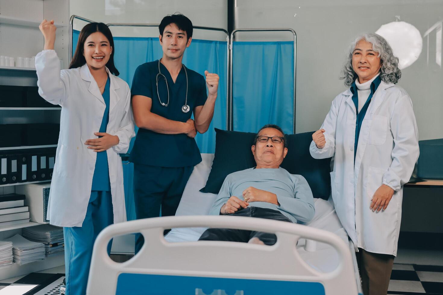 A group of doctors and nurses standing in front of a hospital bed photo