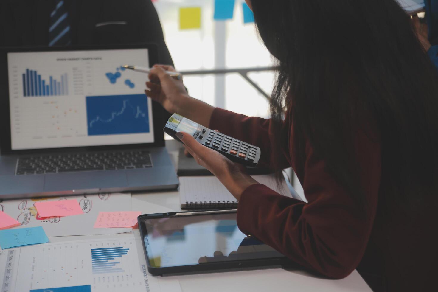 A woman is using a calculator to look at a graph photo