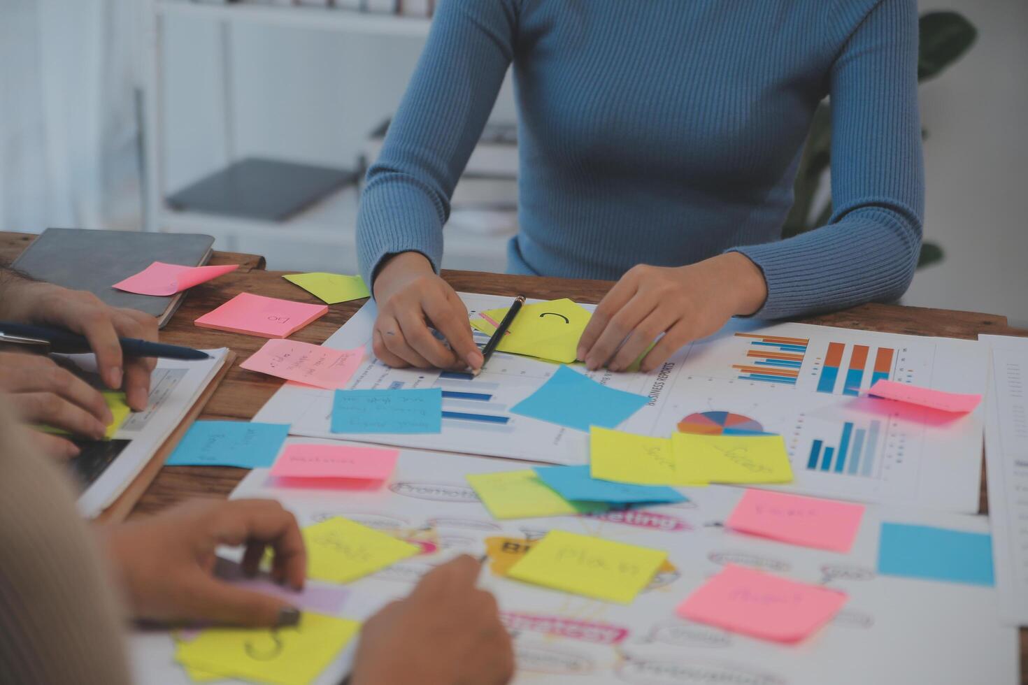 Two people working on a project at a table photo