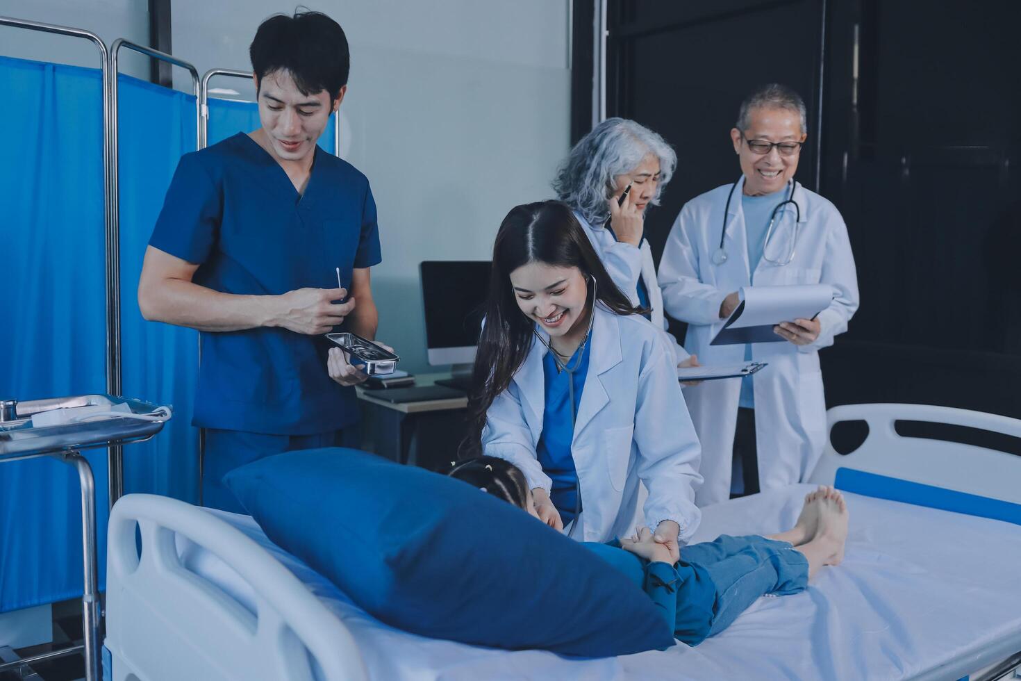 Asian doctors and nurses working in hospital room photo