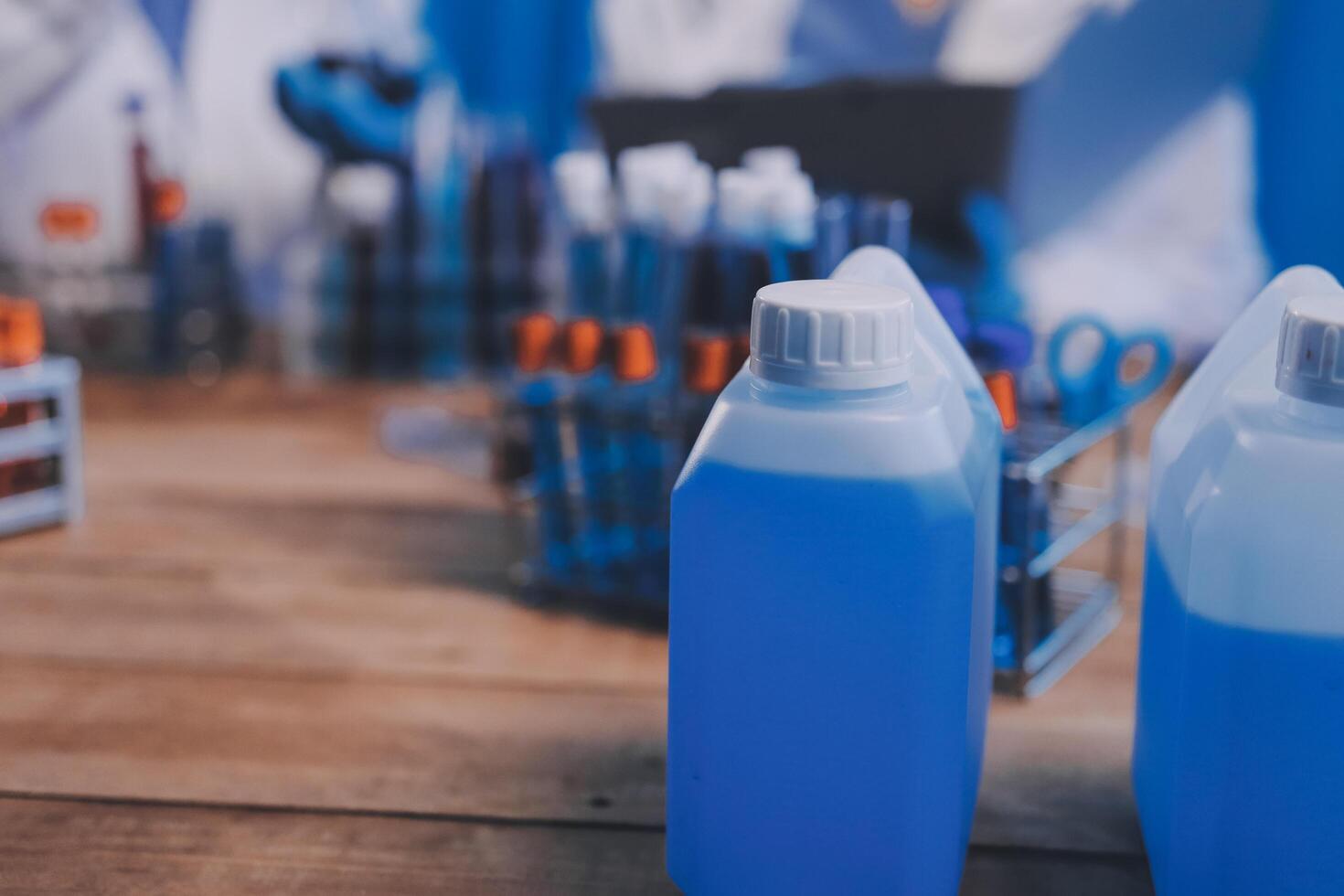 Two bottles of blue liquid sitting on a table photo