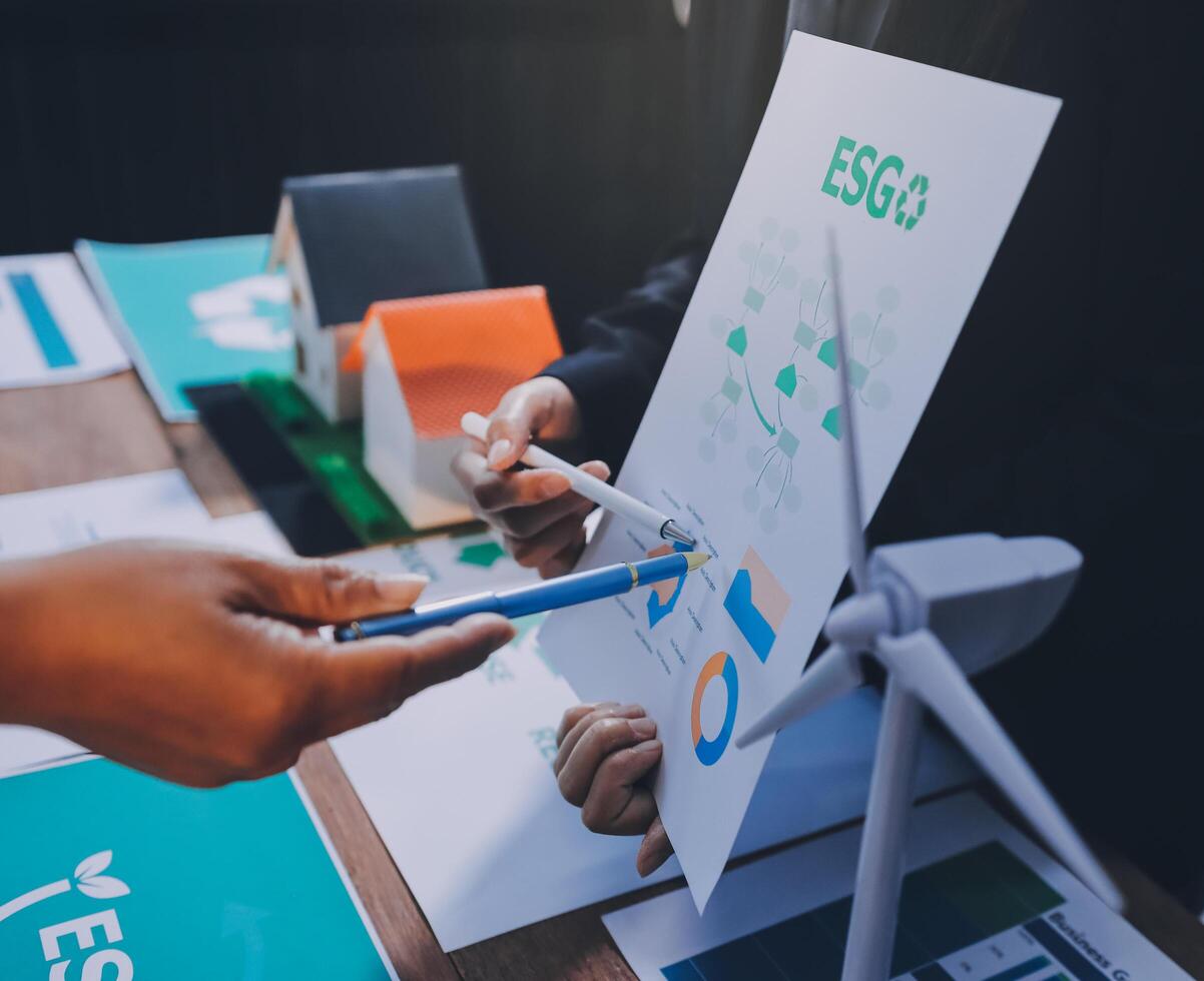 Business people working on a project with a wind turbine photo