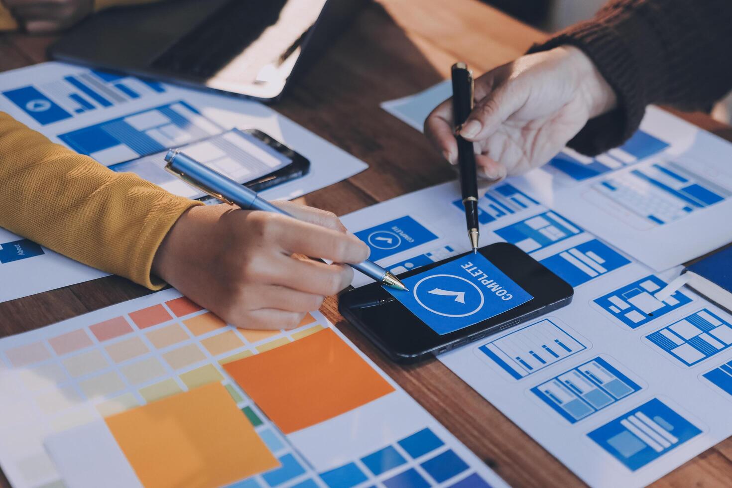 A person is using a smartphone to design a website photo
