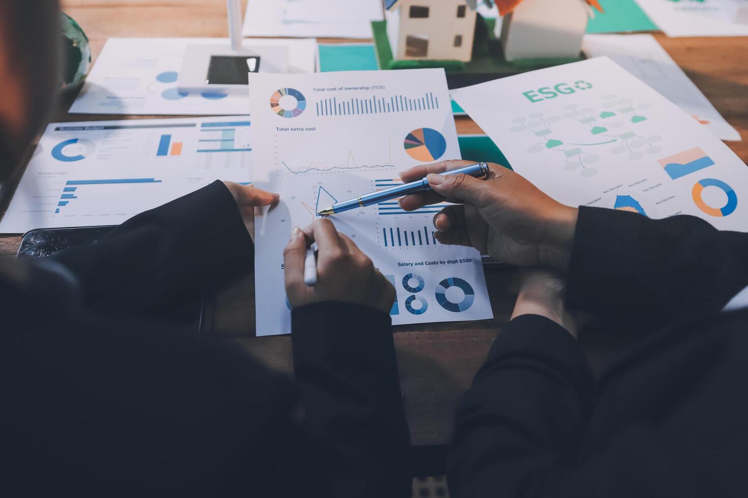 Business people working on papers with graphs and graphs photo