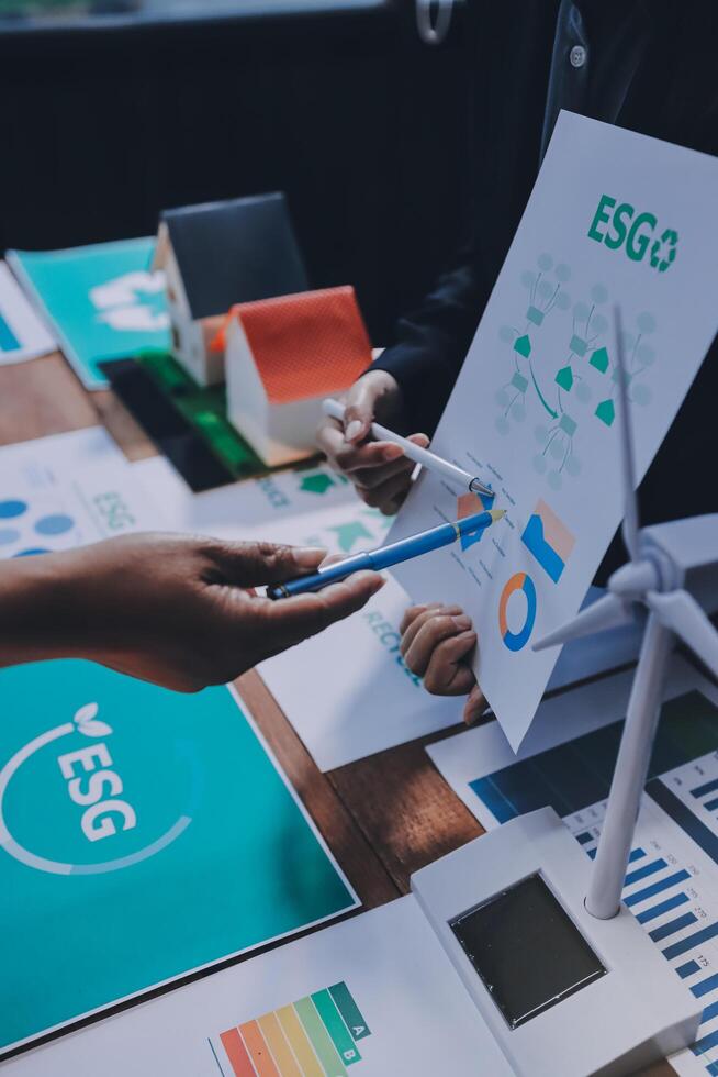 Business people working on a project with a green energy graphic photo