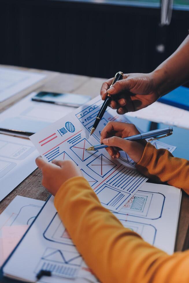 Two people working on a project at a table photo