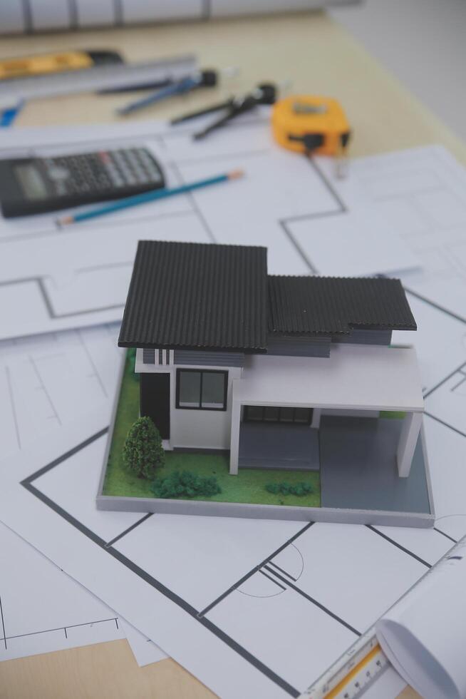 A model of a house is sitting on top of a desk photo