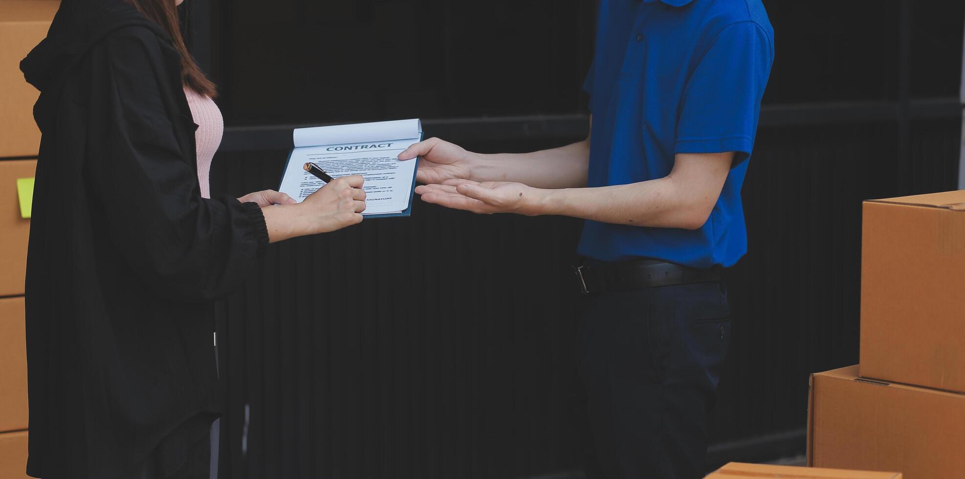 A man and woman are holding a clipboard and a piece of paper photo