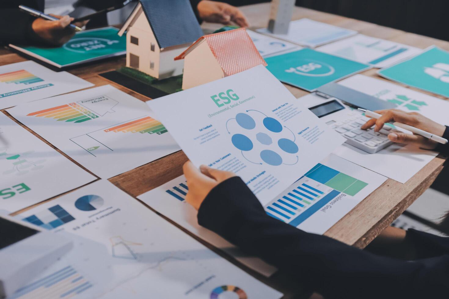 Business people working on a table with various papers photo