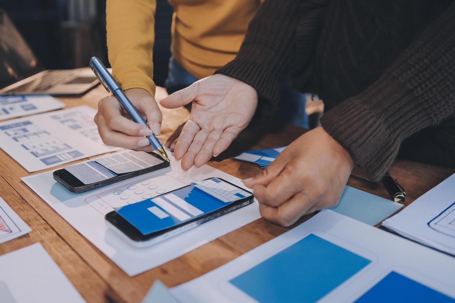 Two people working on a mobile app on a table photo