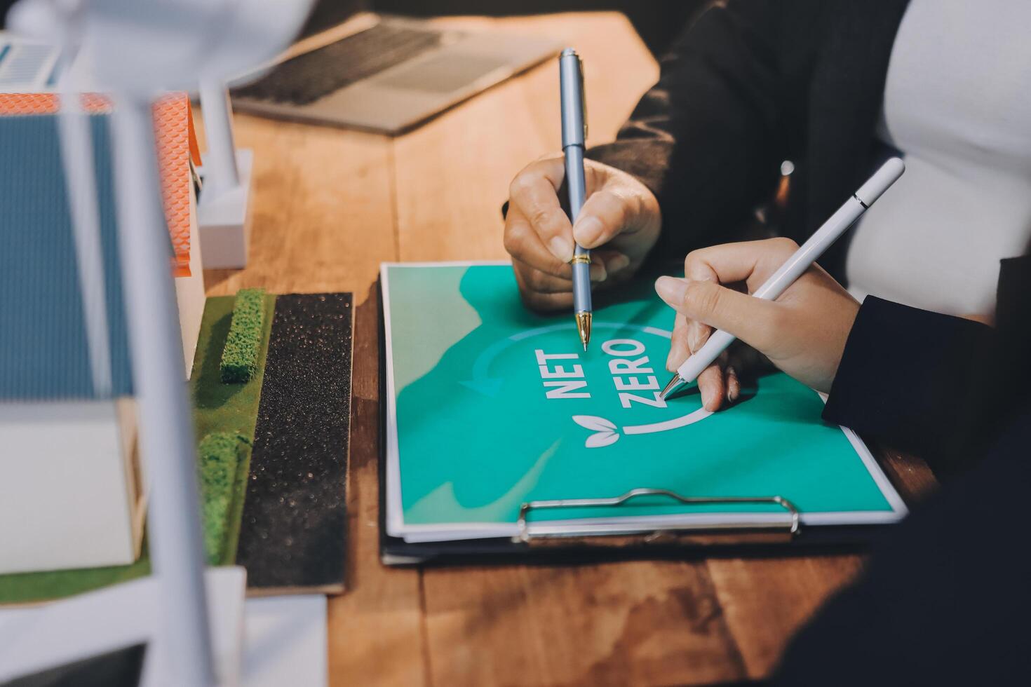 Business people working on a project with net zero logo photo