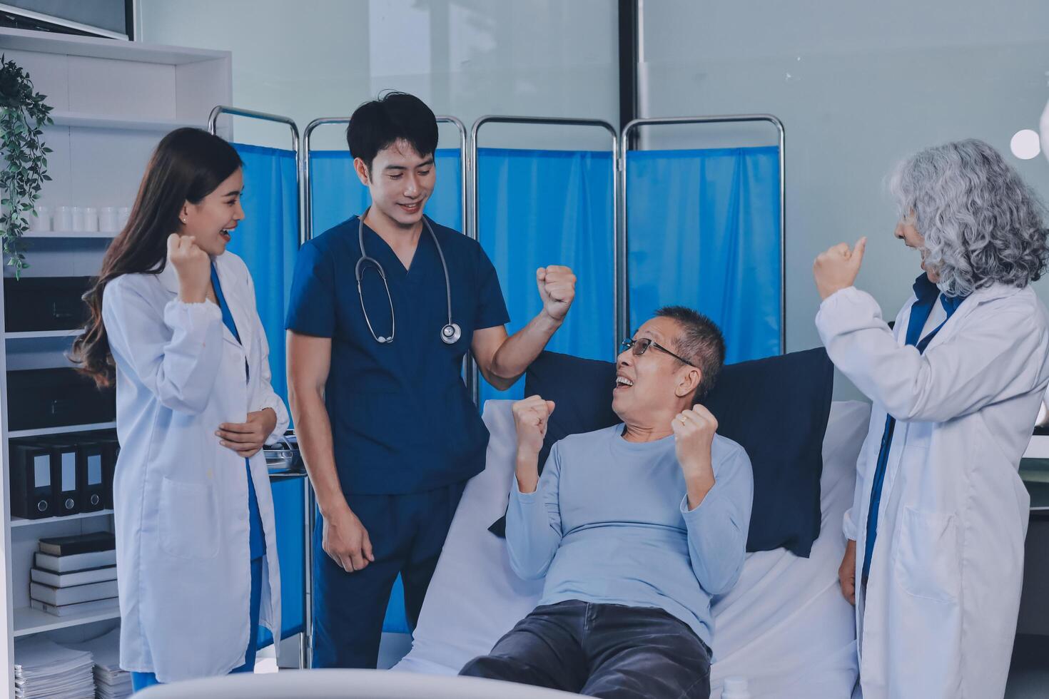 A group of doctors and nurses standing around a patient photo