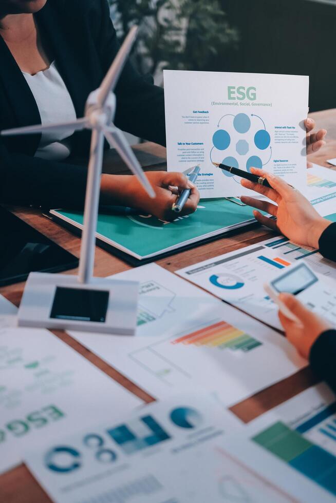 Business people working on a presentation with graphs and papers photo