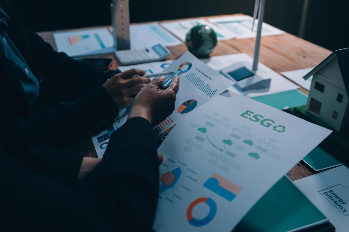 Business people working on a project with a house and a graph photo